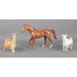 A Royal Doulton ceramic horse, together with two goats; Royal Doulton and Beswick examples. Slight