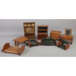 A collection of early Twentieth century wooden dolls house furniture. Includes dresser, drop leaf