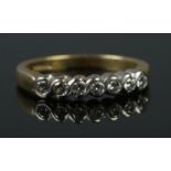An 18ct gold and seven stone diamond ring. Sponsor mark for Fred E Ullman. Size O. 4.24g.