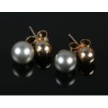 A pair of 9ct gold and grey pearl earrings.