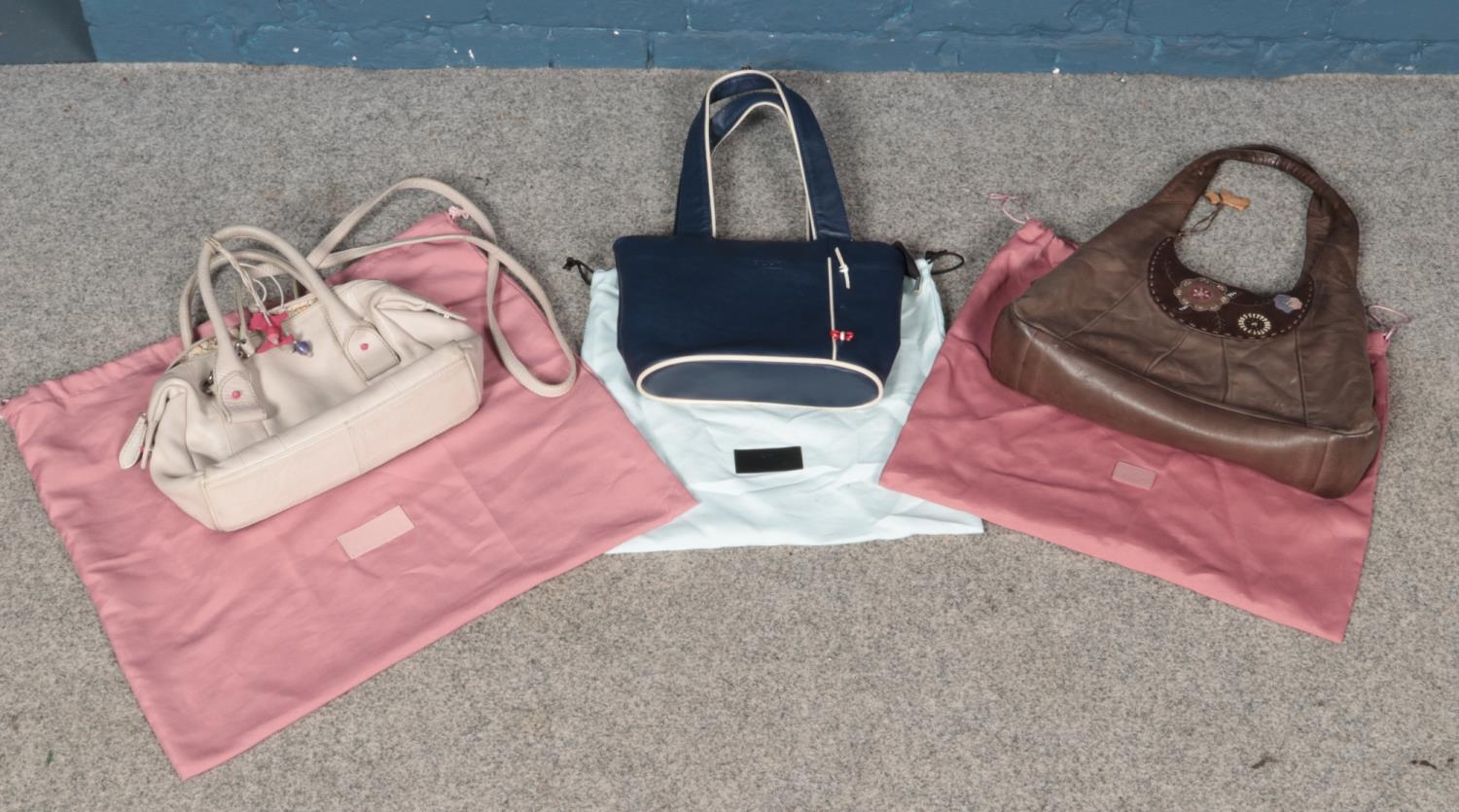 Three Radley handbags, with dust jackets. Some signs of wear to all examples. Radley dog detached