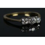 An 18ct Gold and three stone old cut diamond ring, with the largest stone just under Â¼ct. Size O.