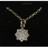 A 10ct gold and diamond cluster pendant on 9ct gold chain. 4.01g. Pendant stamped 10k.