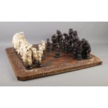 A Reynard the Fox inspired resin chess set, with cream and dark brown pieces. Complete, with