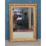 A large ornate gilt framed mirror. 91cm x 66cm.