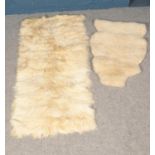 Two sheep skin rugs. Largest example (164cm x 80cm)