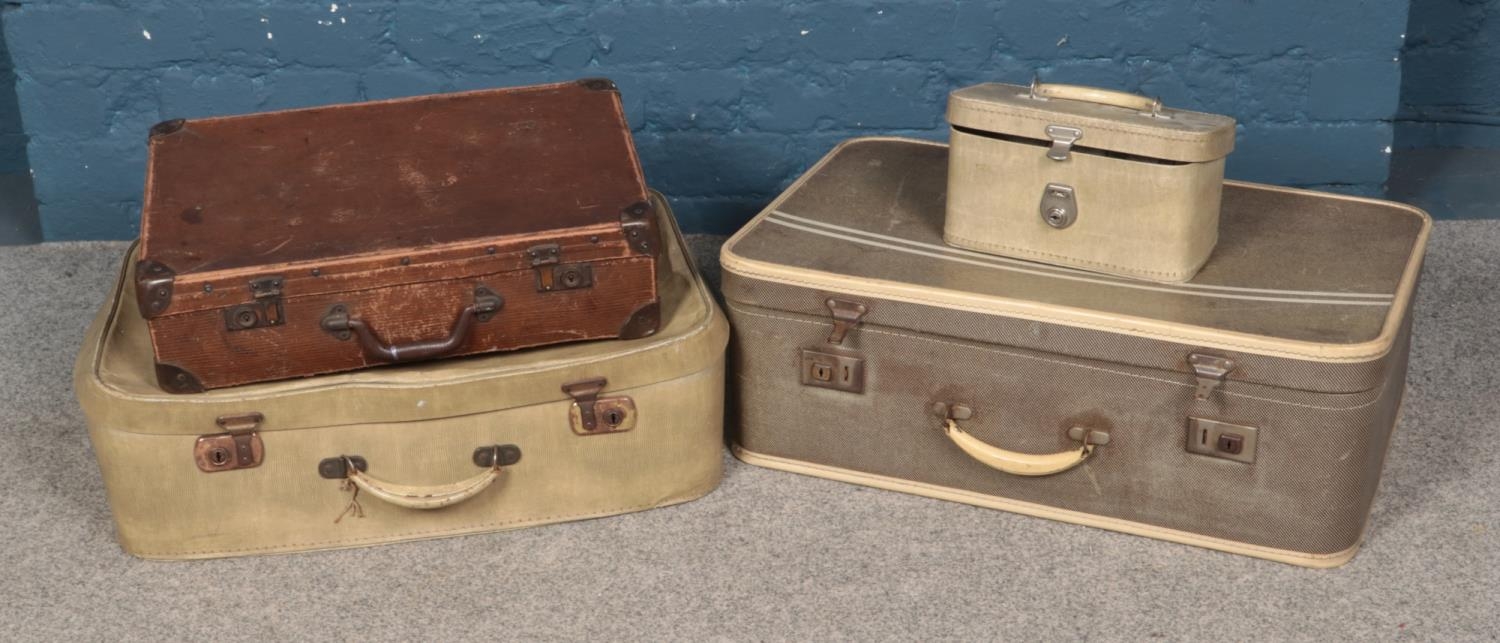 Three assorted vintage travel cases along with a vanity case.