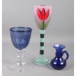 A Kosta Boda drinking glass handpainted with tulips by Ulrica Hydman Vallien along with two blown