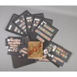 A collection of stamps from around the world including a The Victorian Postage Stamp Album