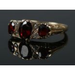 A 9ct gold garnet and clear stone ring. Size L 1/2. 3.45g.