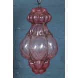 A pink blown glass and wirework hanging light. Glass in good condition. Wire work slightly rusted.