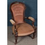 A carved mahogany French style upholstered armchair.