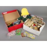 A box of assorted toys. Includes diecast vehicles, Paddington bear, Oxford military building set