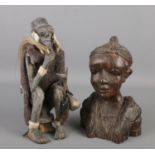 Two African wooden tribal carvings. One of a seated figure, the other a bust. Height of seated