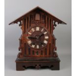 A Black Forest cuckoo clock, with roman numeral dial, chiming on a coiled gong. Movement stamped for
