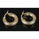 A pair of 14ct hoop earrings featuring engraved decoration. 3.83g.