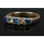 A five stone 9ct diamond and sapphire ring. Size L, 1.91g.