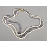 A three row cultured pearl necklace with 18ct gold clasp. Clasp set with clear coloured stones.