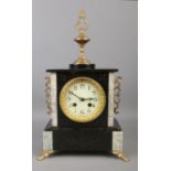 An ornate French slate 8 day mantel clock with brass mount decoration, raised on four brass claw