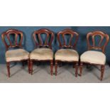 A set of four Victorian carved mahogany dining chairs with upholstered seat.