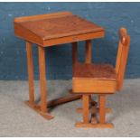 A Taylor's of Leicester child's hinged top desk and chair.