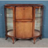 A mid 20th century cocktail cabinet with domed glass doors. Height 113cm Width 115cm Depth 33cm