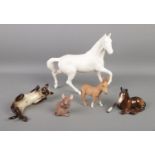 A collection of Beswick ceramic animals, to include matt white horse, mouse, reclining cat, and