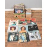 One box of assorted vinyl records and one box of singles, mainly of pop and rock. Examples include