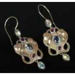 A pair of 9ct gold art and crafts earrings set with moonstones and garnets. 4.05g gross weight.