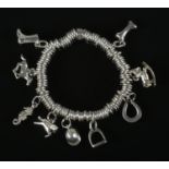 A Links of London silver ring charm bracelet with 9 silver charms including horseshoe, jockey on