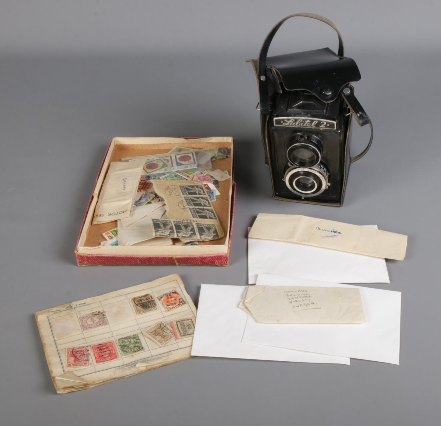 A Lubitel 2 TLR camera with T-22 f/4.5 75mm lens and carry case along with small collection of world