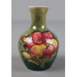 A Moorcroft Pottery green hibiscus design vase. Hx9.5cm