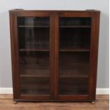 Dark oak two door glazed bookcase cabinet. Hx124cm Wx110cm Dx29cm