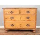 A Pine chest of drawers two small over two large drawers Hx83cm Wx107cm Dx50cm One handle split.