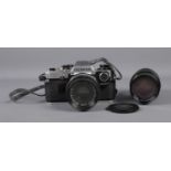 An Olympus OM10 camera along with two Olympus Om-System Zuiko lens: Auto-S 1:1.8 F=50mm and Auto-
