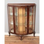 A mahogany bow front China cabinet raised on cabriole legs. Approx. dimensions 90cm x 110cm x