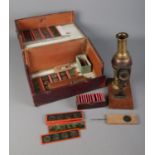 A Victorian brass Lantern Magica magic lantern along with collection of coloured slides in