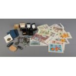 A mix of collectables including a small collection of coins, stamps including Harry Potter examples,