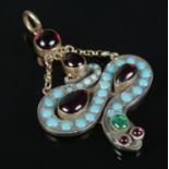 A high carat gold snake pendant set with turquoise and garnets. 7.14g gross. Tested as gold.