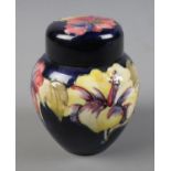 A Moorcroft Pottery ginger jar in cobalt blue with hibiscus design Hx11cm