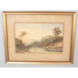 A framed watercolour on board depicting a landscape scene with figures beside a river. Monogramed to