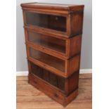 An oak Globe Wernicke four section stacking bookcase. (137cm x 86cm)