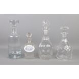 Four glass decanters, with smallest example bearing enameled label for 'Medicinal Brandy'.