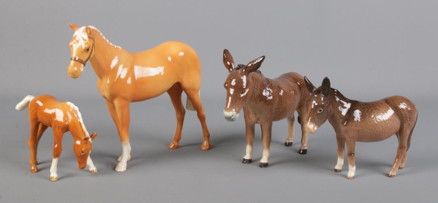 Two Beswick Donkeys, together with two Beswick Palomino horses, H259, and foal. All in good