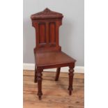 A Victorian carved mahogany hall chair.