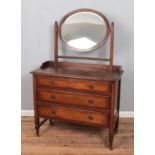 A 1940's oak dressing table with oval bevel edged mirror. Hx159cm Wx105cm Dx46cm