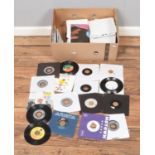 A box of assorted vinyl single records of mainly pop and rock featuring several black label, jukebox