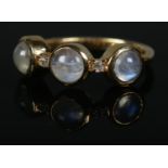 A moonstone and diamond trilogy ring set in 14ct gold vermeil band. Size S, 3.8g