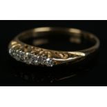 An 18ct gold five stone diamond ring. Size J 1/2, 1.9g.