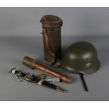 A collection of replica German military items including stick grenade, helmet, dagger and metal